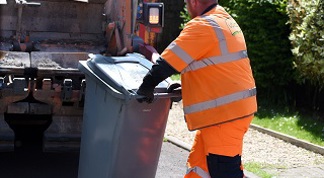 Waste Operative emptying grey residual waste wheelie bin