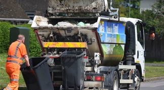 Waste operatives emptying food waste containers